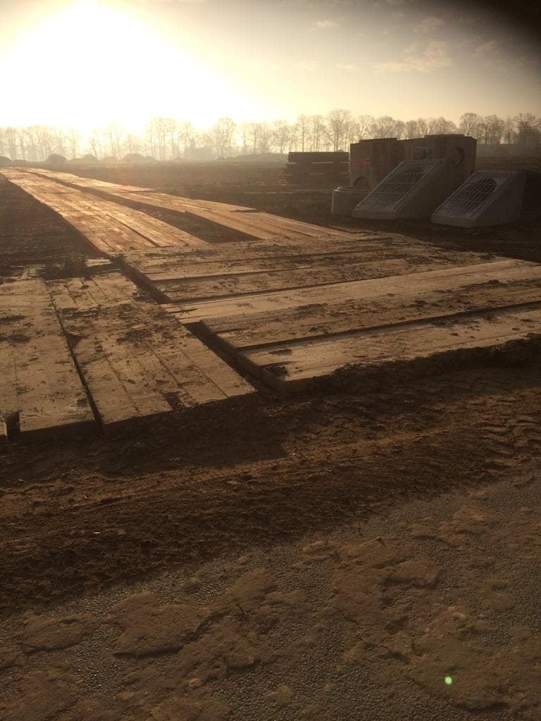 Ground protection mats laid as a temporary access route on a construction site
